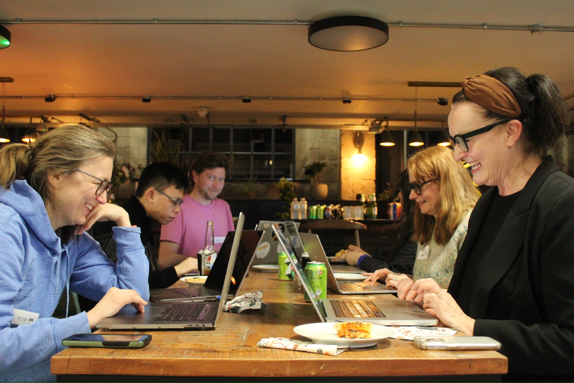 Bath Design Society members laughing together while working on laptops