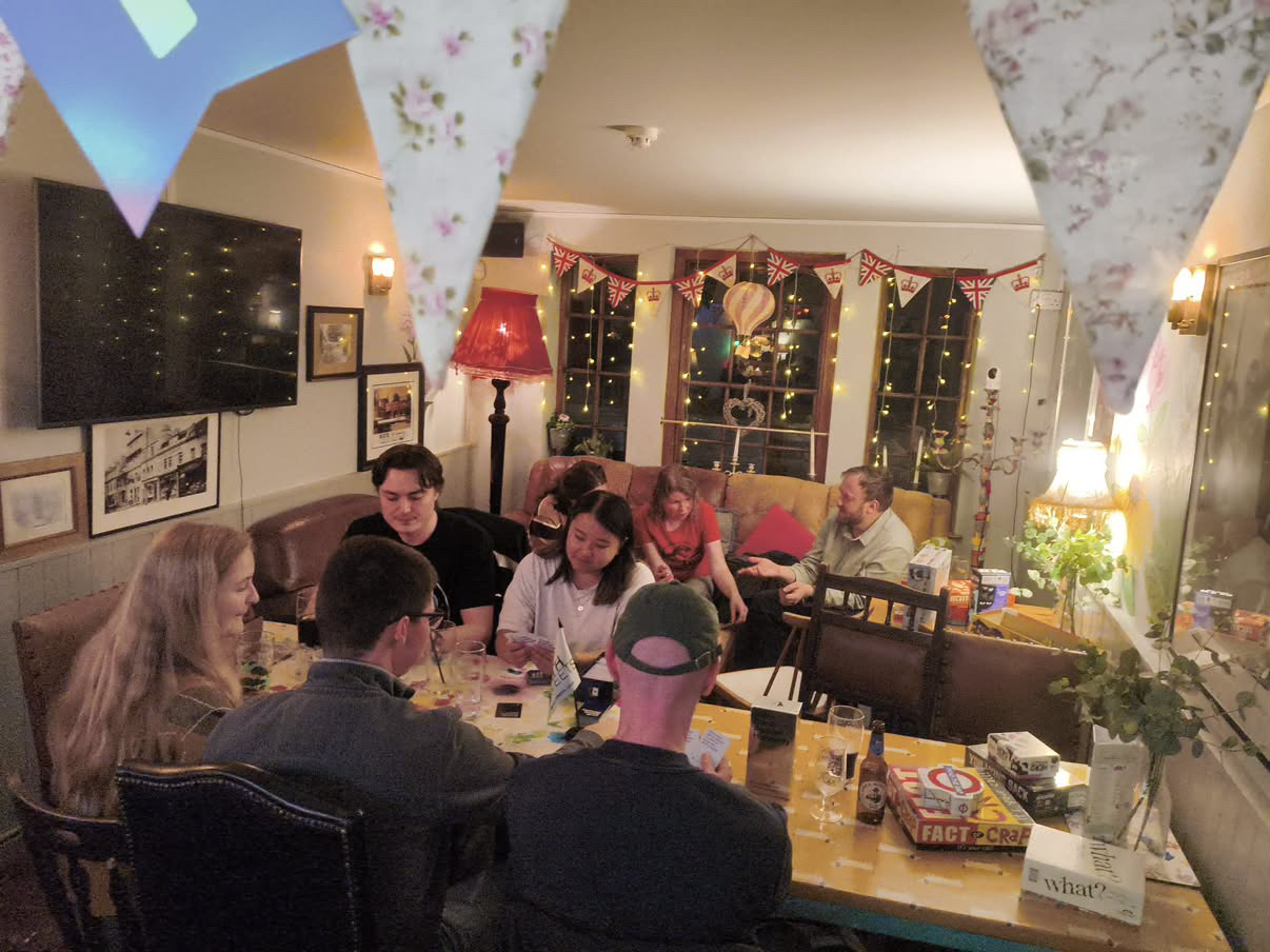 Bath Meets members gathered around a table for a games night